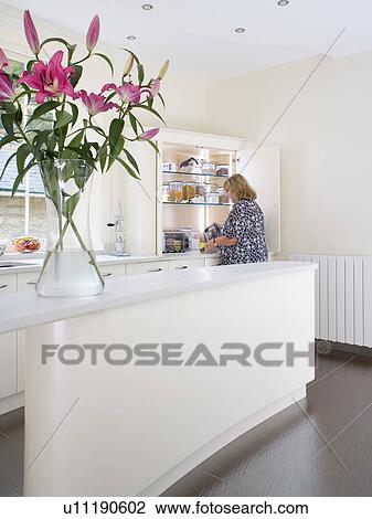 Woman in modern white kitchen View Large Photo Image Stock Image - Woman in modern white kitchen. Fotosearch