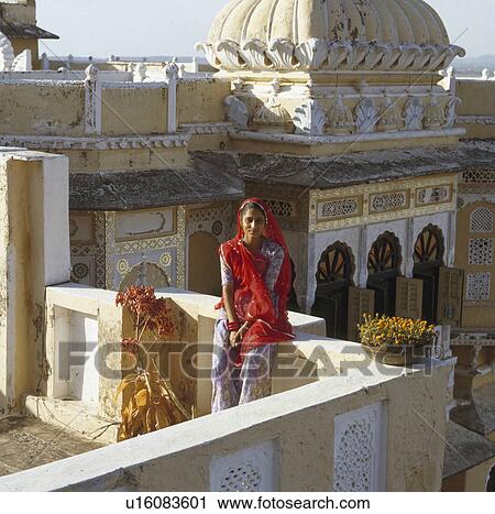 Woman in traditional Rajastani dress sitting on roof terrace of Udai Bilas Palace in Dungarpur View Large Photo Image Stock Image - Woman in traditional Rajastani dress sitting on roof terrace of Udai Bilas Palace in Dungarpur. Fotosearch