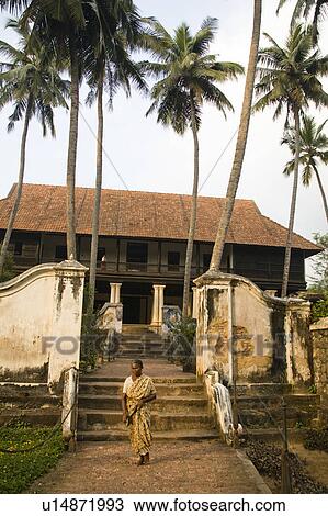Stock Image - Woman walking on path, Padmanabhapuram Palace, Padmanabhapuram, near Thuckalay, Tamil Nadu, India. Fotosearch