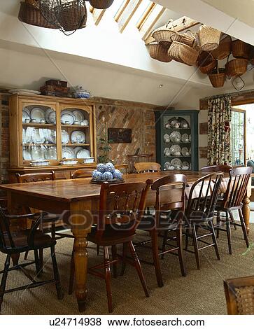 Wooden Chairs And Long Table In Traditional Dining Room Extension With Seasgrass Carpet Baskets On Ceiling Stock Photo U24714938 Fotosearch - Table Dining Room Extension Wooden Chairs And Long Table In Traditional Dining Room Extension With Seasgrass Carpet Baskets On Ceiling Stock Photo U24714938 Fotosearch - Table Dining Room Extension