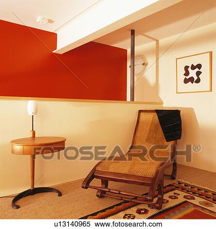 Wooden chaiselongue in modern living room with red wall View Large Photo Image Stock Photography - Wooden chaiselongue in modern living room with red wall. Fotosearch