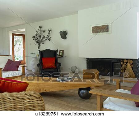 Wooden coffee table in modern white living room with modern fireplace View Large Photo Image Stock Image - Wooden coffee table in modern white living room with modern fireplace. Fotosearch