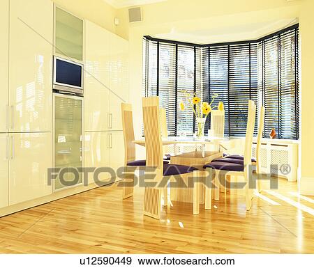 Wooden flooring and high-backchairs in modern dining room with black slatted blind on window and wall-mounted TV View Large Photo Image Stock Photo - Wooden flooring and high-backchairs in modern dining room with black slatted blind on window and wall-mounted TV. Fotosearch