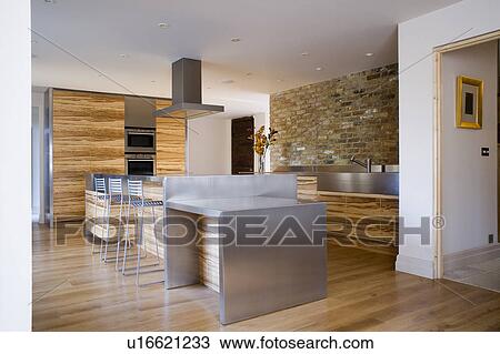 Wooden flooring and stainless steel island unit in modern country kitchen View Large Photo Image Stock Image - Wooden flooring and stainless steel island unit in modern country kitchen. Fotosearch
