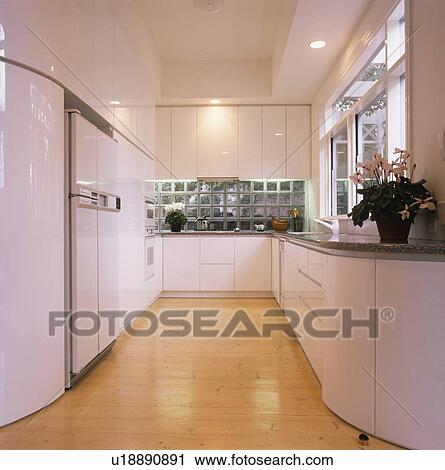 Wooden flooring in large modern white kitchen View Large Photo Image Stock Image - Wooden flooring in large modern white kitchen. Fotosearch