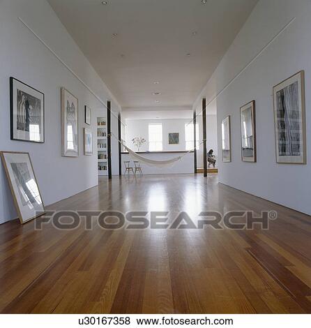 Stock Photo - Wooden flooring in large modern white hall. Fotosearch