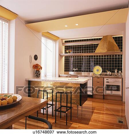 Stock Photo - Wooden flooring in open-plan kitchen dining room. Fotosearch