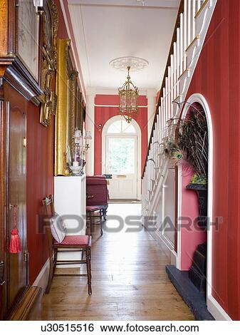 Stock Photograph - Wooden flooring in red country hall . Fotosearch