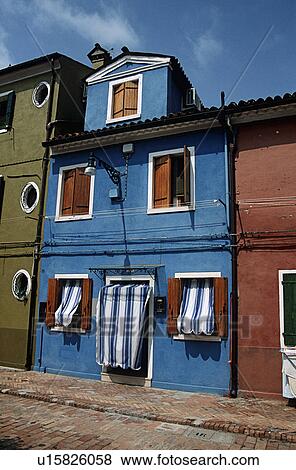 Wooden shutters and blue and white striped awnings on bright blue house on Venetian street View Large Photo Image Stock Photo - Wooden shutters and blue and white striped awnings on bright blue house on Venetian street . Fotosearch