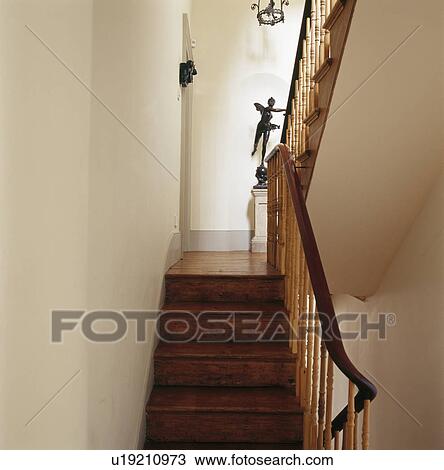 Wooden stairs on cream staircase with spindle bannisters View Large Photo Image Stock Image - Wooden stairs on cream staircase with spindle bannisters. Fotosearch