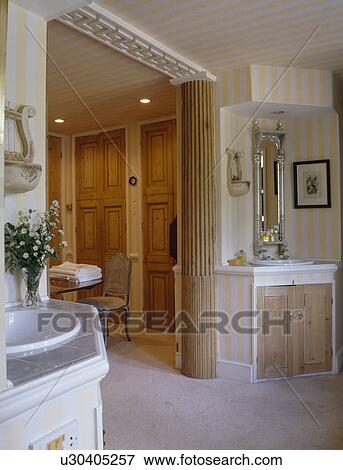Stock Photo - Wooden support pillar in neutral country bathroom. Fotosearch