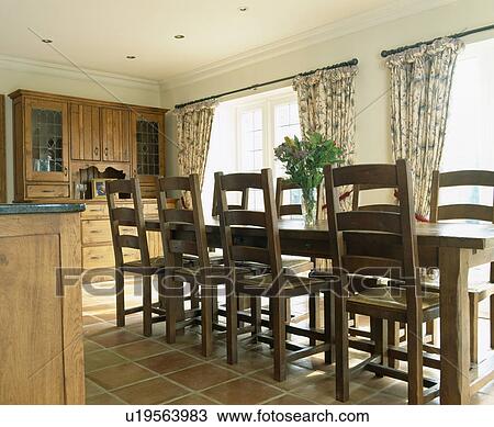 Wooden table and chairs in traditional country kitchen View Large Photo Image Stock Image - Wooden table and chairs in traditional country kitchen. Fotosearch