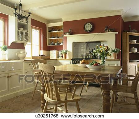 Stock Photo - Wooden table and chairs in traditional country kitchen. Fotosearch