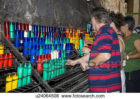 Stock Photo - Worshippers lighting candles inside Montserrat Basilica, Montserrat, near Barcelona, Spain. Fotosearch