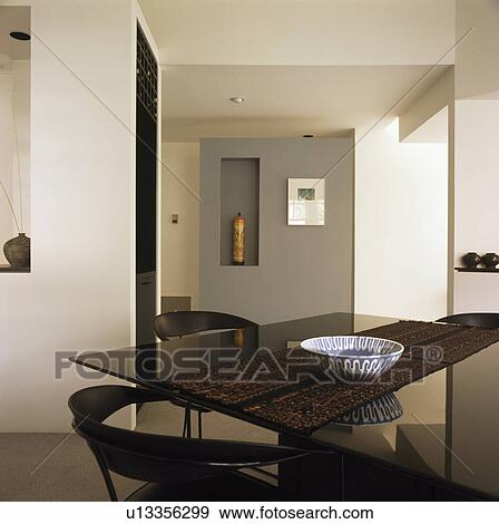 Woven runner on black glass table in modern white dining room View Large Photo Image Stock Photo - Woven runner on black glass table in modern white dining room. Fotosearch