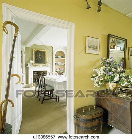 Yellow cottage hall with door open to dining room View Large Photo Image Stock Photo - Yellow cottage hall with door open to dining room. Fotosearch