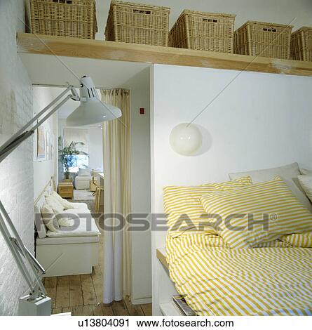 Anglepoise lamp in small bedroom with yellow striped bedlinen View Large Photo Image Stock Image - Anglepoise lamp in small bedroom with yellow striped bedlinen. Fotosearch