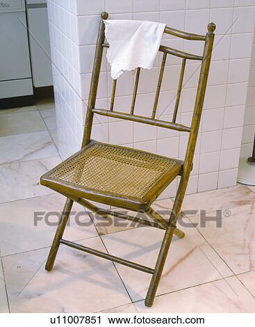 Antique cane and bamboo chair on white tiled floor View Large Photo Image Stock Image - Antique cane and bamboo chair on white tiled floor. Fotosearch