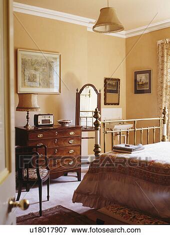 Antique furniture in peach country bedroom View Large Photo Image Stock Photo - Antique furniture in peach country bedroom. Fotosearch