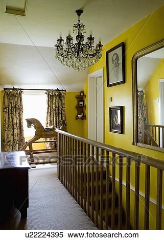 Antique glass chanedlier above yellow landing with cream carpet and rocking horse in front of window View Large Photo Image Stock Photography - Antique glass chanedlier above yellow landing with cream carpet and rocking horse in front of window. Fotosearch