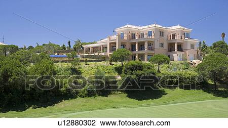 Stock Image - Apartments with swimming pool overlooking golf course,. Fotosearch