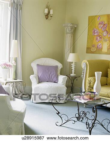 Armchair with mauve cushion and white loose-cover in townhouse living room View Large Photo Image Stock Photo - Armchair with mauve cushion and white loose-cover in townhouse living room. Fotosearch