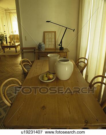 Bentwood chairs and antique pine table in traditional French dining room View Large Photo Image Stock Photo - Bentwood chairs and antique pine table in traditional French dining room. Fotosearch