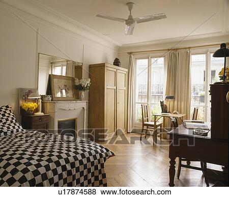 Black+white checked bedcover on French townhouse bedroom with parquet floor View Large Photo Image Stock Photo - Black+white checked bedcover on French townhouse bedroom with parquet floor. Fotosearch