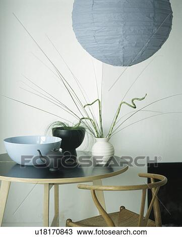 Blue paper lampshade above small black dining table View Large Photo Image Stock Image - Blue paper lampshade above small black dining table. Fotosearch