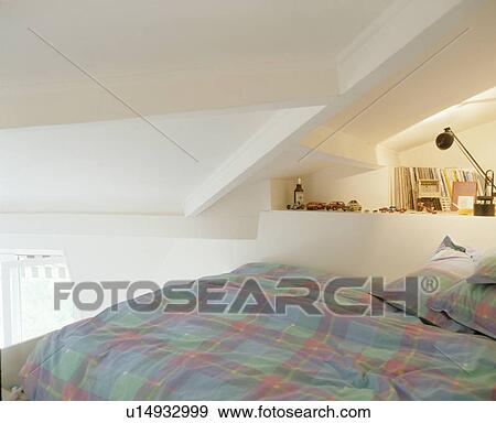 Blue+green checked duvet and pillows on bed on mezzanine in attic bedroom View Large Photo Image Stock Photo - Blue+green checked duvet and pillows on bed on mezzanine in attic bedroom. Fotosearch