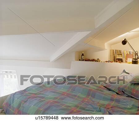 Blue+green checked duvet and pillows on bed on mezzanine in attic bedroom View Large Photo Image Stock Photo - Blue+green checked duvet and pillows on bed on mezzanine in attic bedroom. Fotosearch