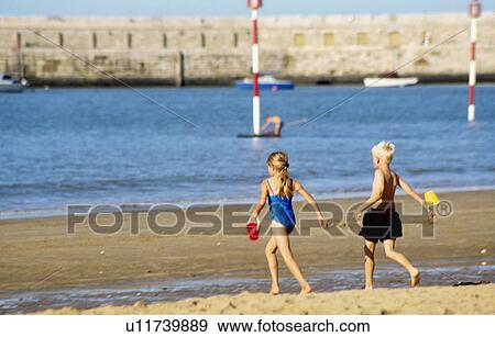 Boy and girl with buckets running across the sand to the sea at Margate in Kent View Large Photo Image Stock Photo - Boy and girl with buckets running across the sand to the sea at Margate in Kent. Fotosearch