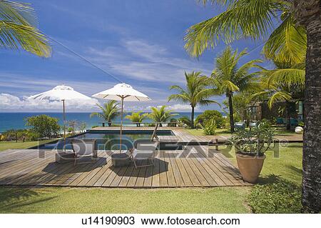 Stock Image - Brazil. Outdoor patio. Beach. Chairs. Umbrellas.. Fotosearch
