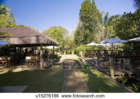 Stock Photograph - Brazil. Outdoor patio. Thatched roof.. Fotosearch