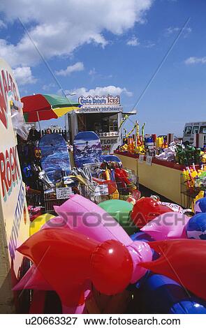 Stock Photo - Brightly coloured plastic objects at the fairground at Walton on Naze in Essex. Fotosearch