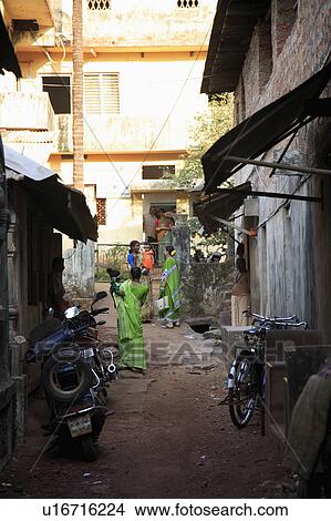 Picture - Busy local pathway between house in Indian town.. Fotosearch