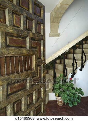 Stock Photo - Carved wooden door open to hall. Fotosearch