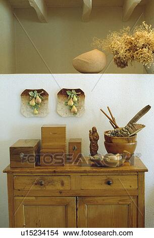 Picture - Ceramic fruit plaques above collection of antique wooden boxes on old pine cupboard. Fotosearch