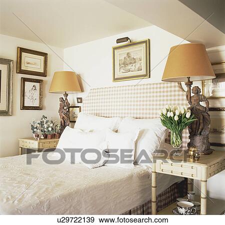 Checked upholstered headboard on bed with white pillows in small bedroom View Large Photo Image Stock Photo - Checked upholstered headboard on bed with white pillows in small bedroom. Fotosearch