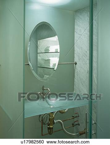 Circular mirror above modern glass basin View Large Photo Image Stock Image - Circular mirror above modern glass basin. Fotosearch