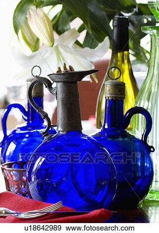 Stock Photo - Close-up of antique blue Bristol glass decanters. Fotosearch