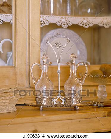 Close-up of antique glass vinegar and oil bottles on Art Nouveau server View Large Photo Image Picture - Close-up of antique glass vinegar and oil bottles on Art Nouveau server. Fotosearch