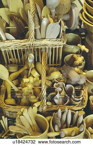 Stock Image - Close-up of baskets of antique wooden utensils and cutlery. Fotosearch