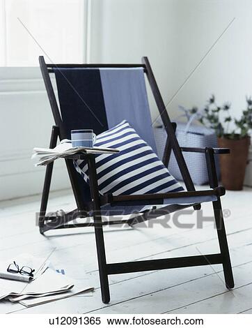 Close-up of black+white striped cushion on blue+black deckchair View Large Photo Image Stock Photography - Close-up of black+white striped cushion on blue+black deckchair. Fotosearch