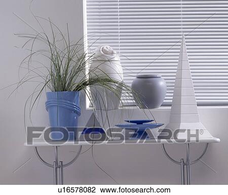 Stock Image - Close-up of blue and silver vases on white shelf. Fotosearch