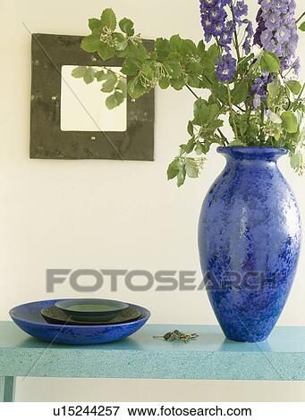 Close-up of blue delphiniums in bright blue vase on turquoise table View Large Photo Image Stock Photo - Close-up of blue delphiniums in bright blue vase on turquoise table. Fotosearch