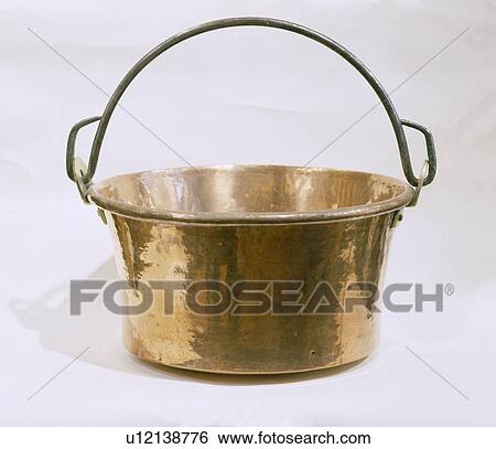 Stock Photograph - Close-up of brass pan with handle. Fotosearch