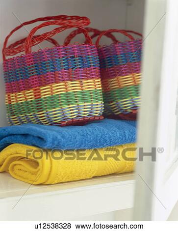 Stock Photo - Close-up of brightly coloured woven baskets on yellow and turquoise rugs. Fotosearch
