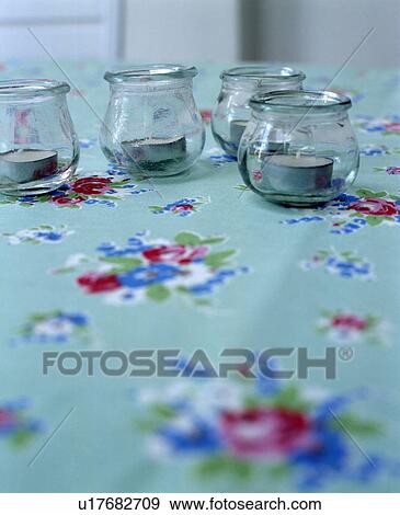 Close-up of candles in glass jars on turquoise floral tablecloth View Large Photo Image Stock Photo - Close-up of candles in glass jars on turquoise floral tablecloth. Fotosearch