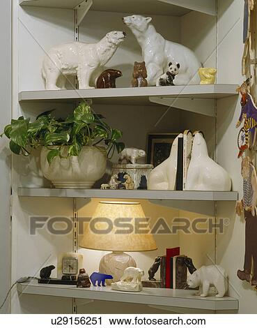 Close-up of collection of white ceramic animals on white corner shelves View Large Photo Image Stock Image - Close-up of collection of white ceramic animals on white corner shelves. Fotosearch